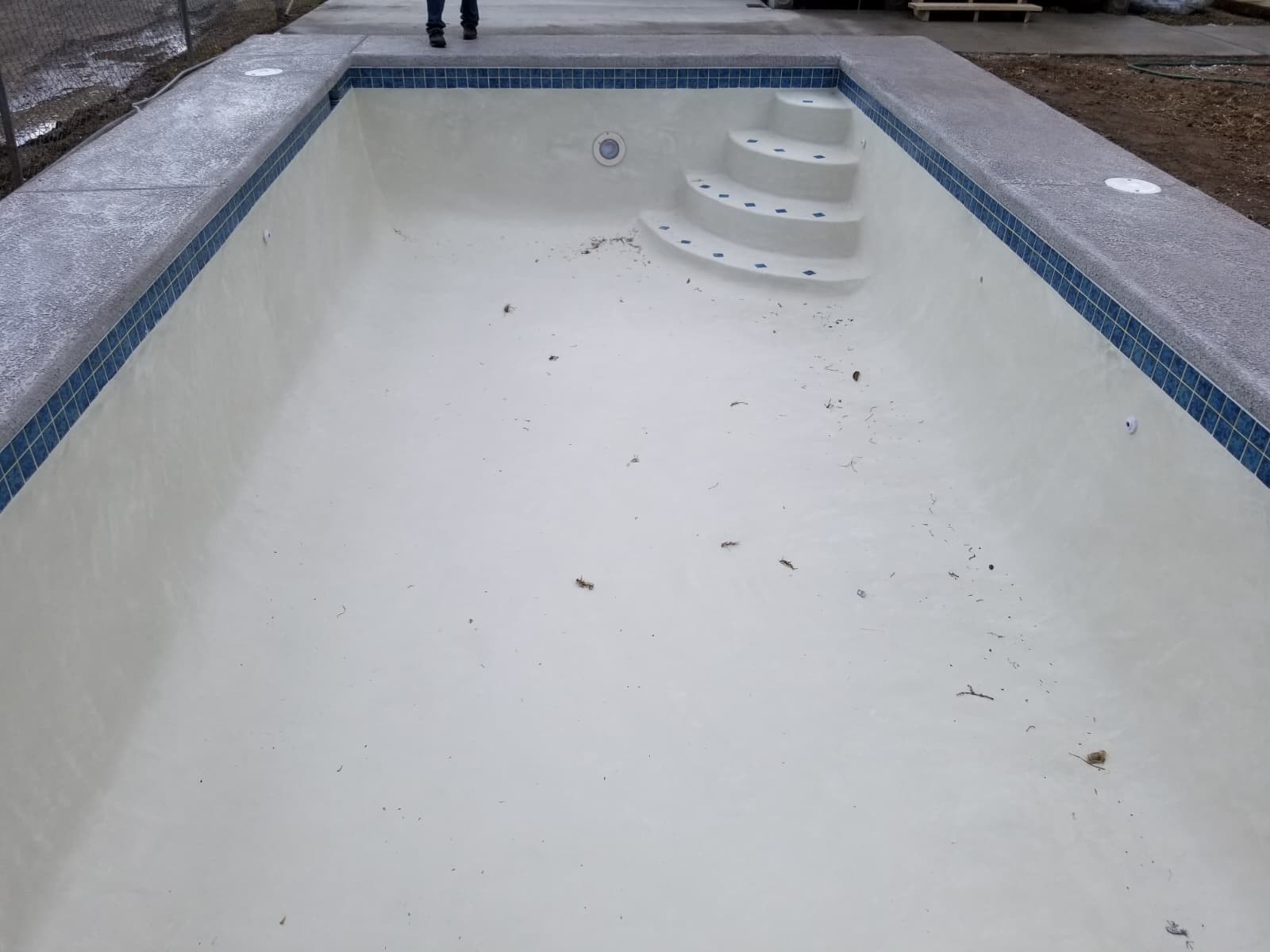 Freshly plastered pool shell with steps, ready for water